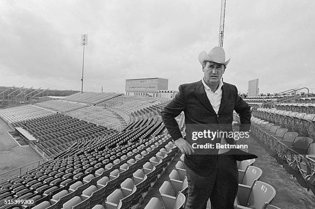 Texas Rangers' Manager Ted Williams walks through a gusty wind here, as he surveys Turnpike Stadium, in the Dallas suburb of Arlington, the new home...