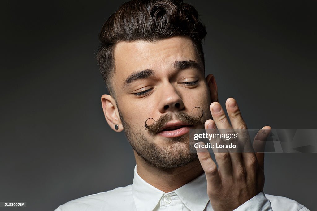 Portrait of young man with long moustaches