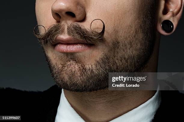 close up of young man with long moustaches - moustaches stockfoto's en -beelden