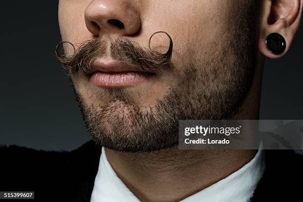 close up of young man with long moustaches - moustaches stock pictures, royalty-free photos & images