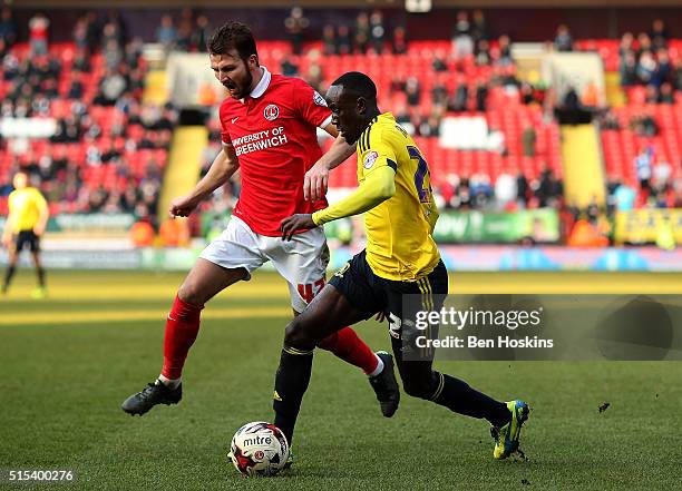 Albert Adomah of Middlesbrough holds off pressure from Marco Motta of Charlton during the Sky Bet Championship match between Charlton Athletic and...