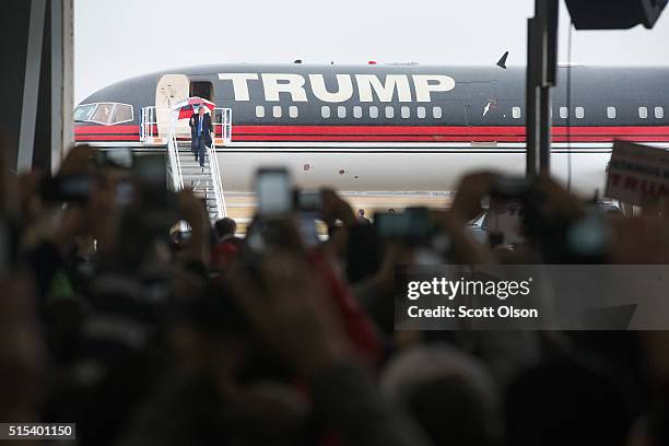 Republican presidential candidate Donald Trump arrives for a rally at the Central Illinois Regional Airport on March 13, 2016 in Bloomington,...