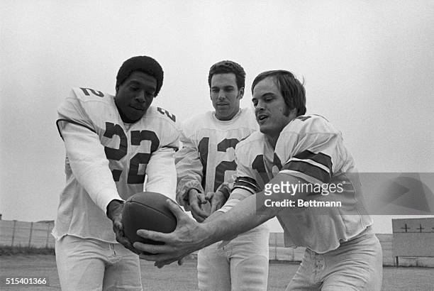 Roger Staubach , Dallas Cowboys' quarterback, flips the ball to his two favorite long receivers Bob Hayes and Lance Alworth prior to practice for the...