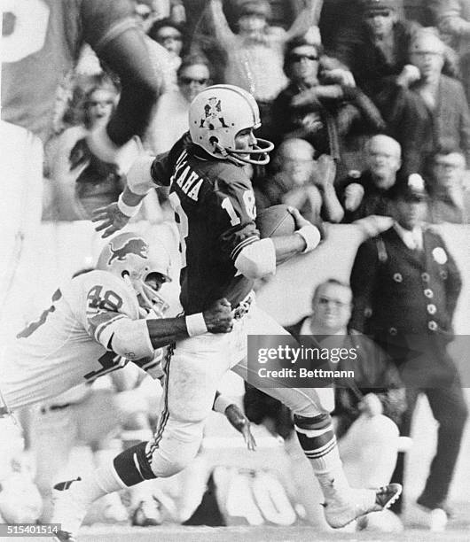 New England Patriots, wide receiver Randy Vataha, runs with the ball away from a tackle by a member of the Detroit Lions.