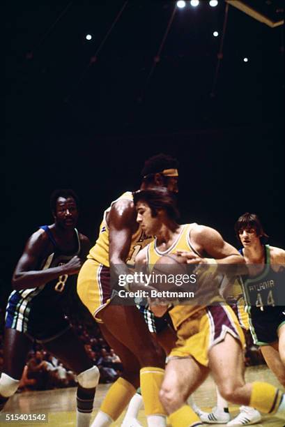 Inglewood, California: Wilt Chamberlain (130 of the Los Angeles Lakers hands off to teammate Gail Goodrich as Walt Bellamy and Pete Maravich of the...