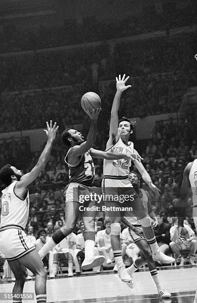 Jerry Lucas of the Knicks goes up to block a shot by Elgin Baylor of the Los Angeles Lakers during an exhibition game here. The Knicks won 126-114...