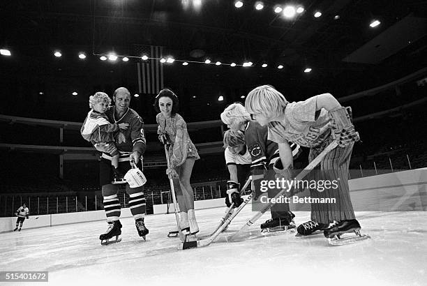 It's almost a team as all five Hulls shown Peggy Fleming, reigning Olympic and Figure Skating Champion, and star of the Ice Follies, what hockey is...