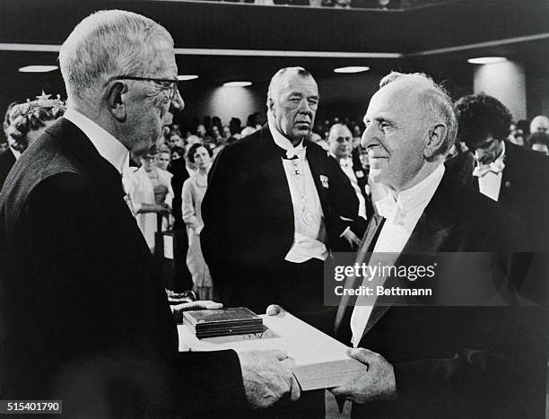 Russian born Simon S. Kuznets, of Harvard University accepts his Nobel Prize in Economics from Sweden's King Gustav Adolf in a Pentecostal church...