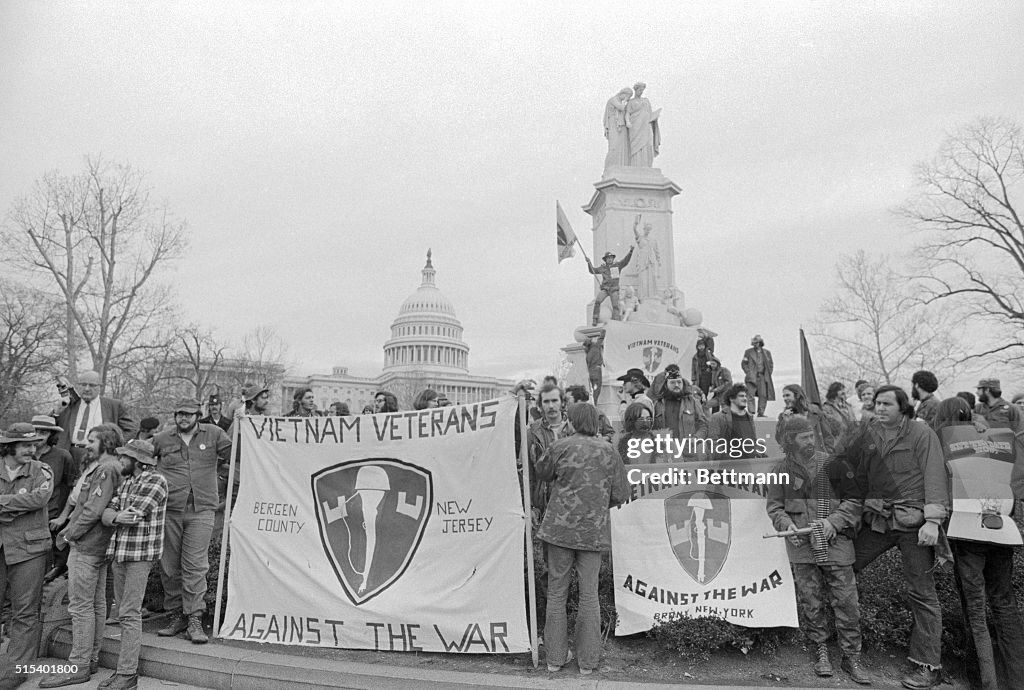 War Protesters Standing in Front of Capitol with Banners