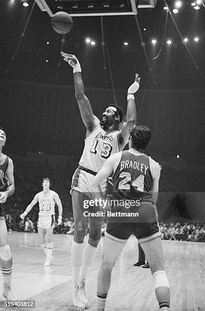 Inglewood, Calif.: Wilt Chamberlain of the Los Angeles Lakers wears a big smile as New York Knicks' Jerry Lucas wears a grimmace resulting from...