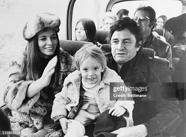 American country and western star Johnny Cash and his wife June Carter joke with their son John in a bus at the Frankfurt Rhine-Main airport after...