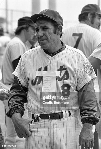 Coach Yogi Berra of the New York Mets finds a unique place to tape a listing of team's starting line-up as the former world champions get set to face...