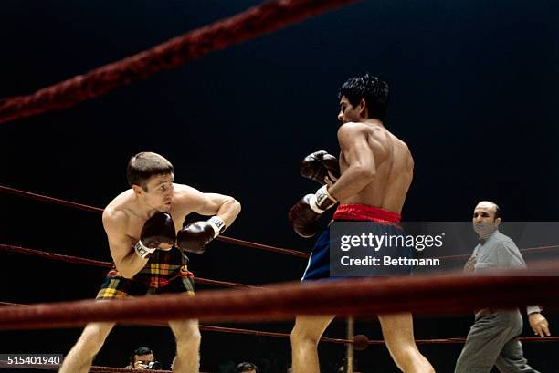 Action during the lightweight championship fight between Ken Buchanan and Roberto Duran at Madison Square Garden. Referee John LoBianco looks on.