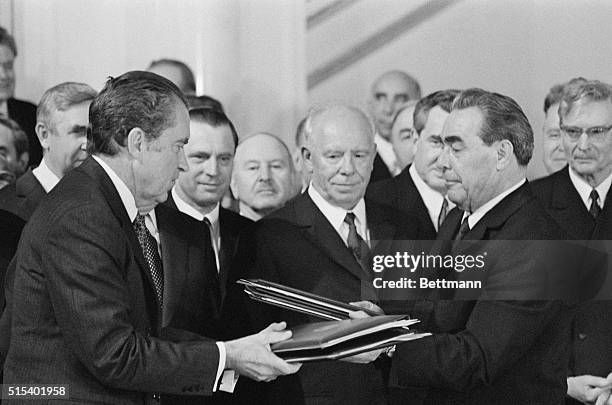 President Nixon and Communist Party Chief Leonid I. Brezhnev exchange copies of the signed treaty designed to halt the nuclear arms race, in this...