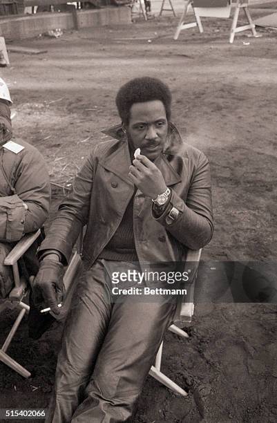 Richard Roundtree eats an orange between location shots for the movie The Big Bamboo at the Brooklyn Navy Yard in New York City.