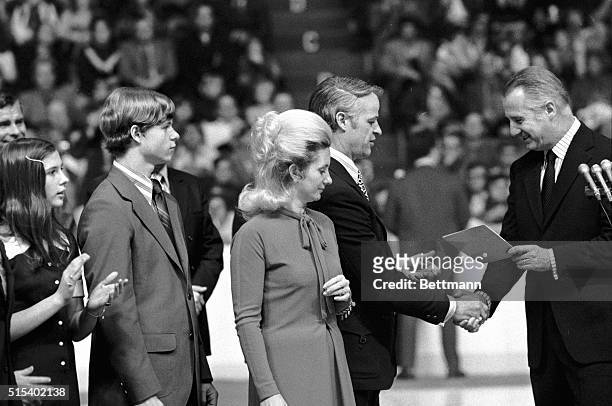 While Colleen Howe looks on, Vice President Spiro Agnew presents a letter of recognition from President Nixon to Gordon Howe during pre-game...