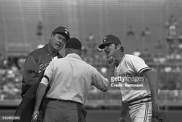 Texas Rangers' manager Ted Williams, , and Don Mincher, 1st baseman, , argue with home plate umpire Jim Odom here, as Odom throws Mincher out of the...