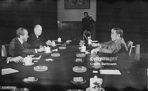 President Richard Nixon and John Holdridge, staff member of the National Security Council, sit across conference table from Chinese Premier Chou...