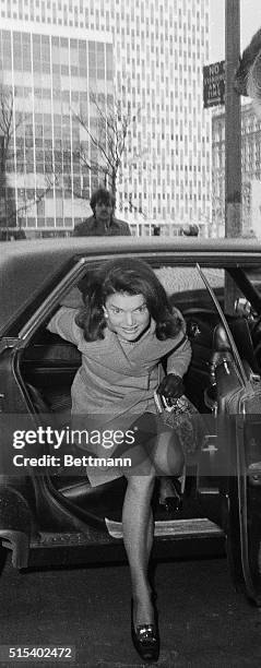 Jackie Onassis shows a lot of leg, as she arrives here at the Federal Court where she faced cross examination by veteran attorney Alfred Julian, who...