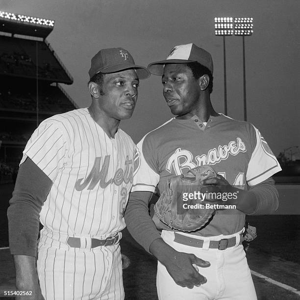 Mets Willie Mays talking to Atlanta Braves Hank Aaron at Shea Stadium. They tied with 648 lifetime homers - second to Babe Ruth.