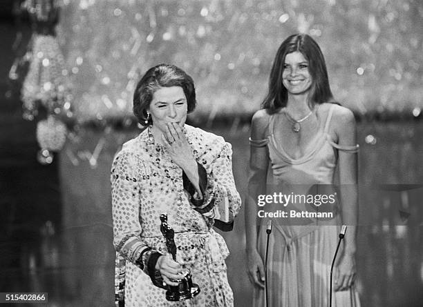 Hollywood, California: Actress Ingrid Bergman throws a kiss to the audience as presenter, Katherine Ross, stands behind her as she was announced the...