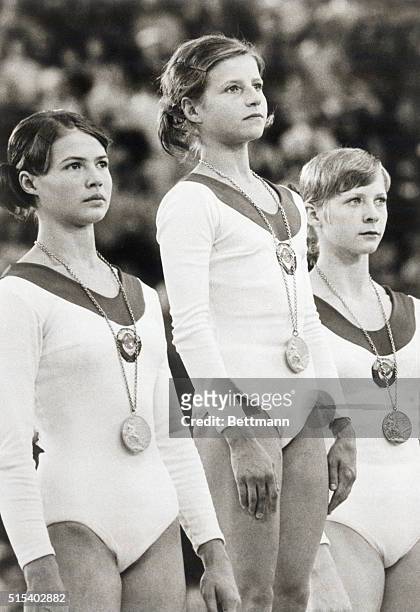 Munich: Russia's Olga Korbut wears her gold medal for individual gymnastics during the medals award ceremony here. Flanking her are runners-up...