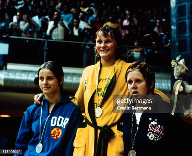 Shane Gould wears the gold medal she won for her world record win in the 200 meter women's medley. With her are Kornelia Ender of East Germany ,...