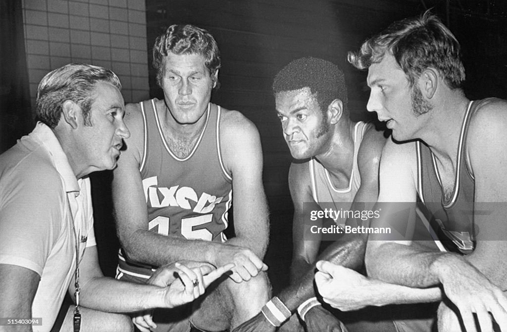 Basketball Coach Talking to Three Players