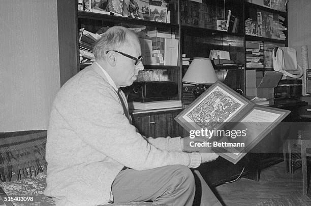 Viewing his Nobel Peace Prize citation is Andrei Sakharov in his Moscow home in 1975.