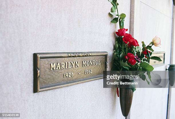 Actress Marilyn Monroe's crypt in Westwood Memorial Park, with a spray of red roses.