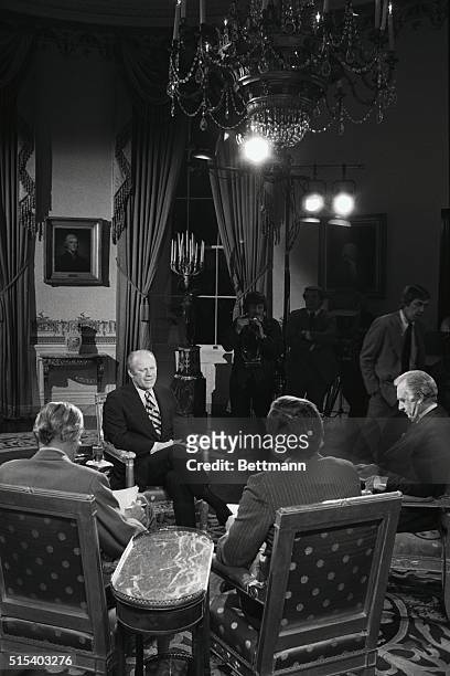 President Ford chats with CBS-TV correspondents as they prepare for their interview with the Chief Executive from the Blue Room of the White House....