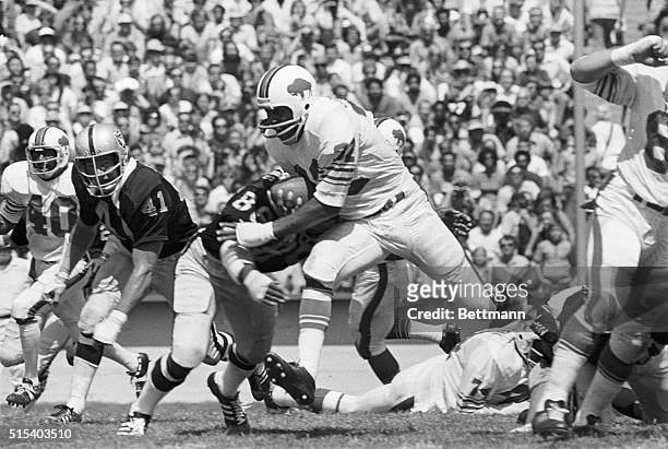 Buffalo Bills' O.J. Simpson romps over right tackle for 4 yards before being brought down by Middle Linebacker Gerald Irons during 2nd quarter action...