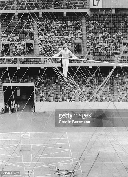 High wire dare devil Philippe Petit makes his way across the cable suspended 200 feet above the floor of the Louisiana Superdome. The stuntmen...