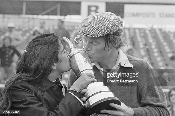 Tom Watson and his wife Linda kiss trophy he has just been awarded 7/13 for winning 18-hole playoff in British Open golf tournament. Watson edged...