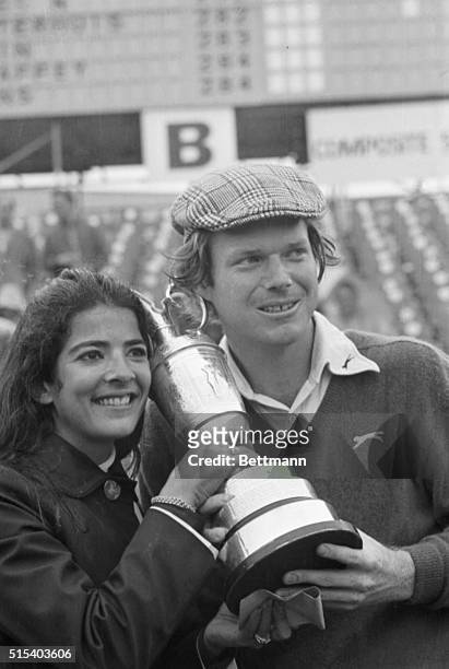 Tom Watson and his wife Linda hold trophy he has just been awarded 7/13 for winning 18-hole playoff in British Open golf tournament. Watson edged...