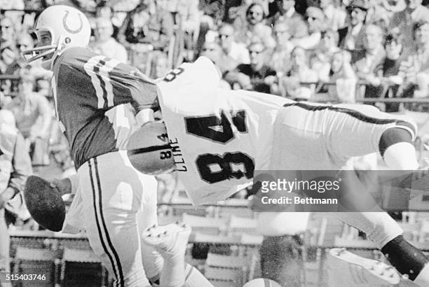 September 28, 1975- Baltimore, Maryland: Oakland Raiders' defensive end Tony Cline is taken for a ride by Baltimore Colts' quarterback Bert Jones...