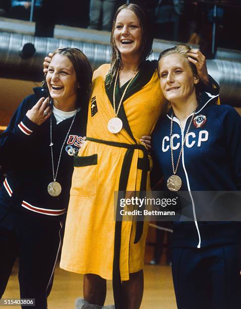 Munich, Germany.Beverly Whitfield of Australia stands, wearing her gold medal, flanked by Dana Schoenfield, of USA, the second place winner, and...