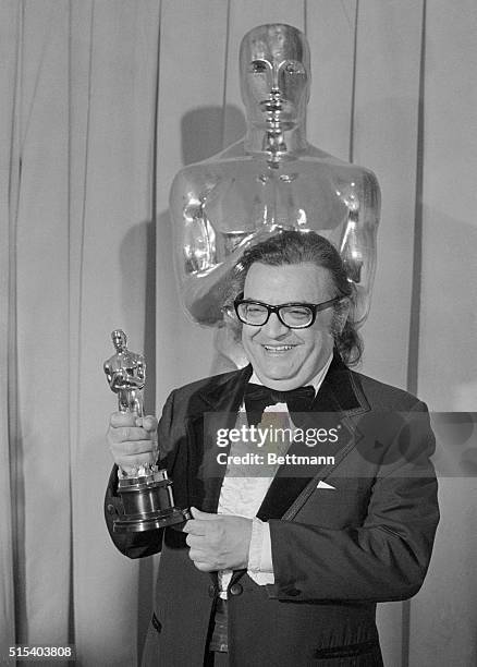 Mario Puzo proudly holds his Oscar for best screenplay, for The Godfather Part II, at the 47th annual Academy Awards presentation. He shared this...