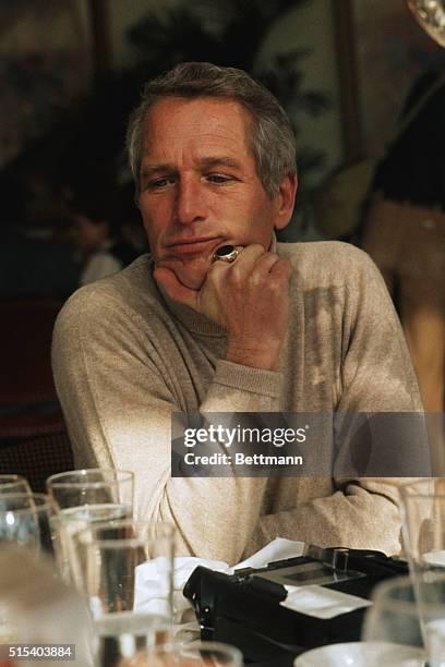 Sitting in a reflective mood while attending a luncheon marking the opening of his latest movie Slap Shot, 51-year-old Paul Newman listens while...