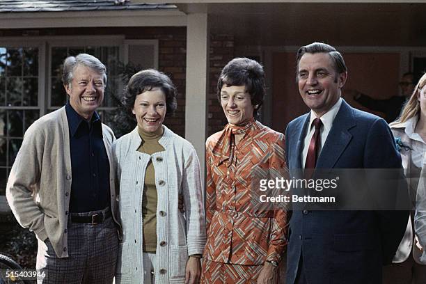 Plains, Georgia: President-elect Jimmy Carter with his wife Rosalyn, Mrs. Mondale and her husband Walter , Vice-president elect, chat while posing...