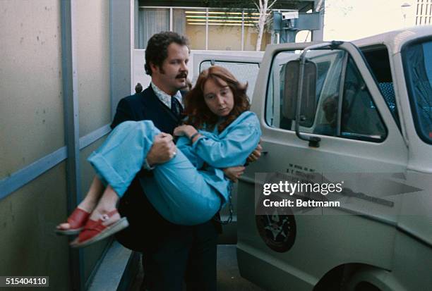 Lynette Fromme, follower of Charlie Manson, is carried into the federal courthouse by a U.S. Marshall during trial.