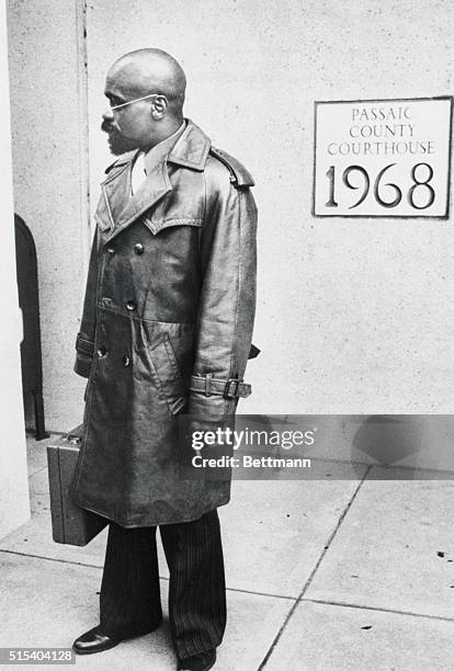 Paterson, New Jersey:--Rubin "Hurricane" Carter on his way into Passaic county courthouse on the third day of his murder trial. Carter had previously...