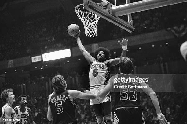 In this bit of action, San Antonio Spurs' Billy Paultz and Mark Olberding seem to be admiring the amazing grace of Philadelphia 76ers' Julius Erving...