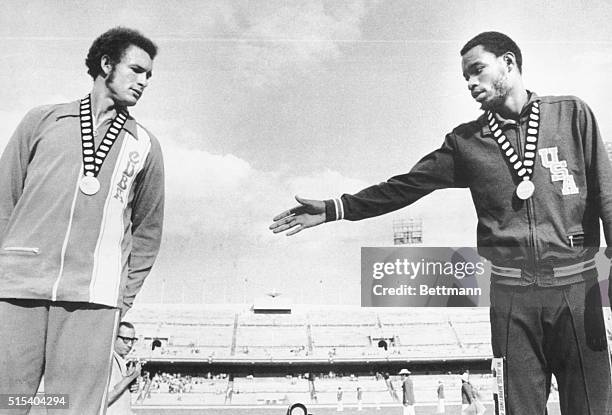 Mexico City: American 400-meters winner Donald Ray, Durham, North Carolina, holds out his hand to a hesitant Cuban, Alberto Juantorena, who finished...