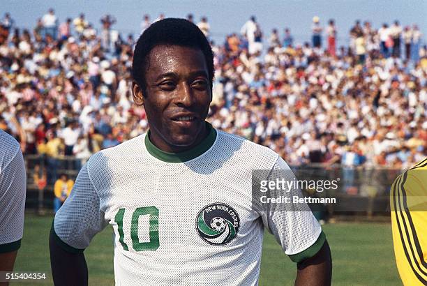 Miami, Florida: Head and shoulders portrait of the New York Cosmos soccer sensation Pele standing on the field in New York Cosmos uniform. The crowd...