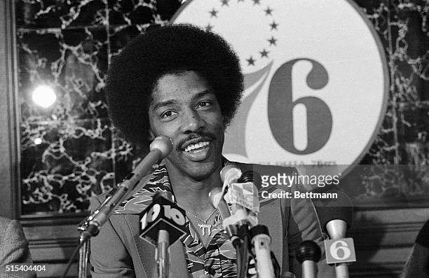 Smiling Julius Erving greets newsmen here 10/21 after he signed a 3.5 million dollar contract with the Philadelphia 76ers. Erving had been playing...