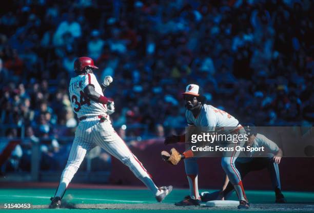 Eddie Murray of the Baltimore Orioles covers first base and waits for the throw against Gary Matthews of the Philadelphia Phillies as he gets back to...