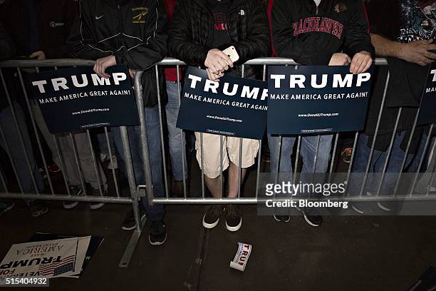 Attendees hold campaign signs ahead of a campaign event with Donald Trump, president and chief executive of Trump Organization Inc. And 2016...