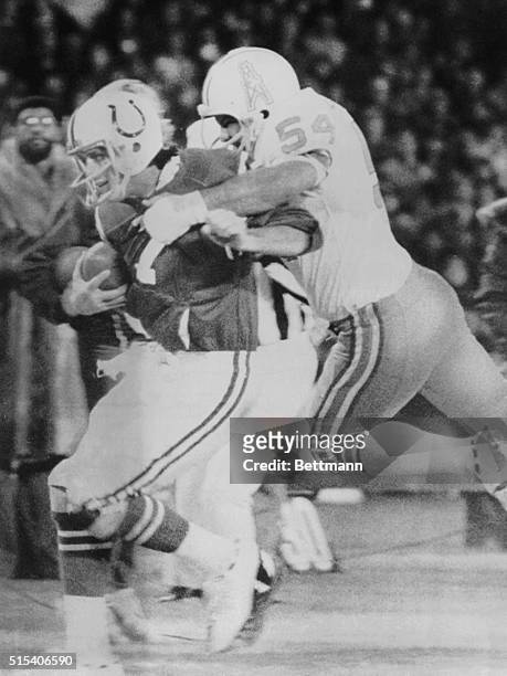 Baltimore Colts' quarterback Bert Jones is tackled out of bounds by Houston Oilers' linebacker Gregg Bingham during first quarter action of their...