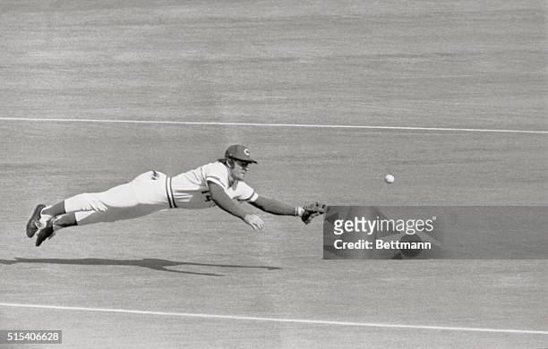 Reds' third baseman Pete Rose dives for Yank's Roy White's grounder in first inning of World Series opener 10/16. The ball hit off Rose's glove and...